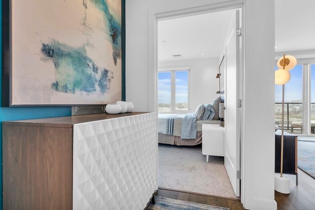 a living room with furniture and a painting on the wall