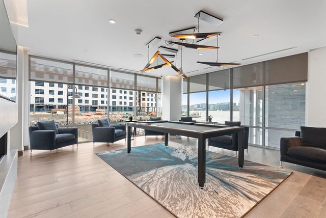 a living room with couches a coffee table and a table with wooden floor