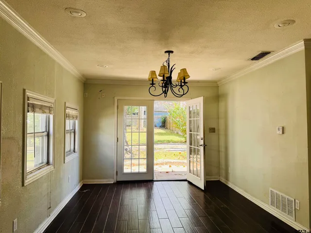 a view of an entryway with wooden floor
