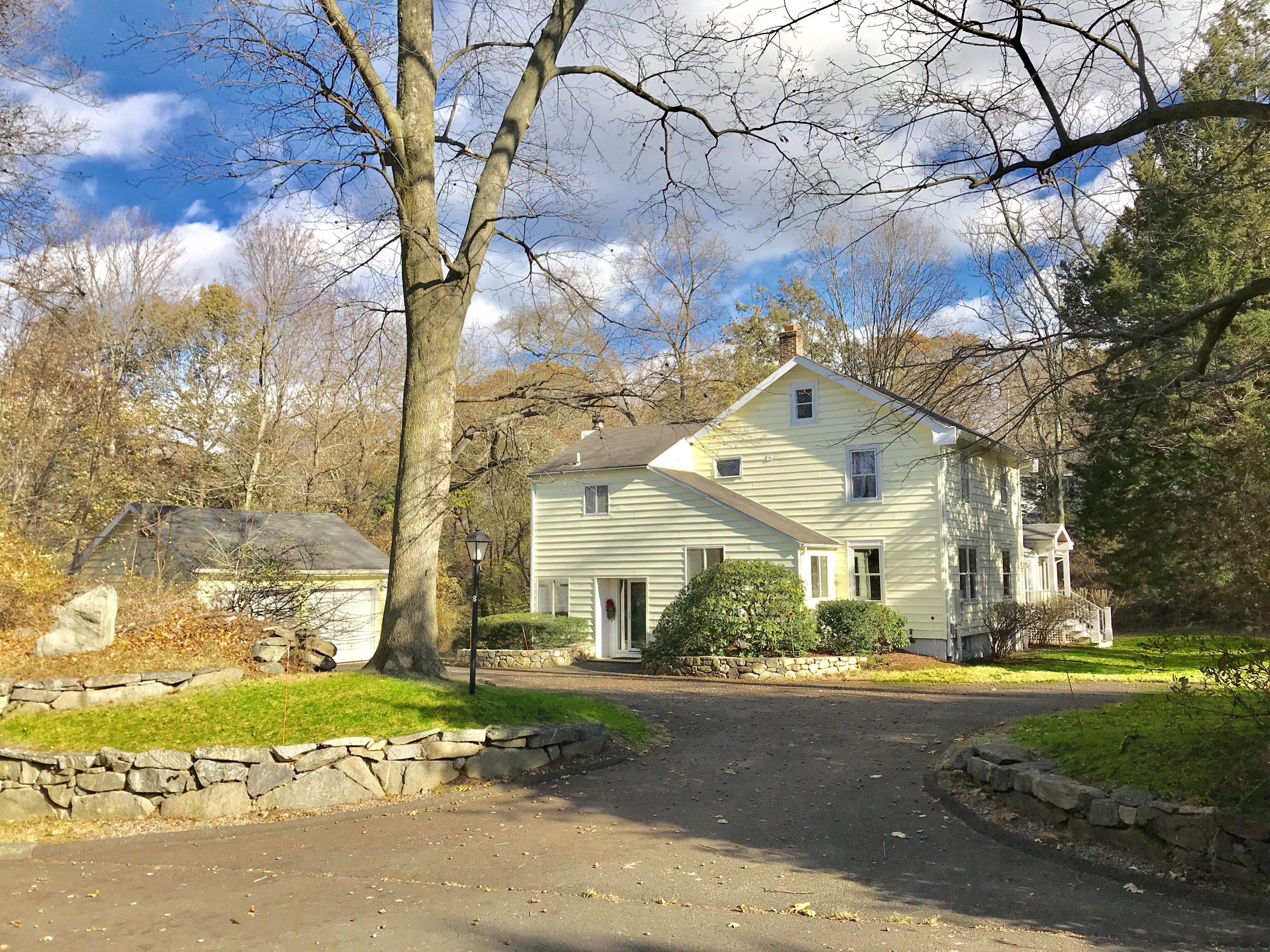 6 Locust Hill Road Darien, CT 06820 - Photo 1 of 18 a front view of a house with a yard and garage