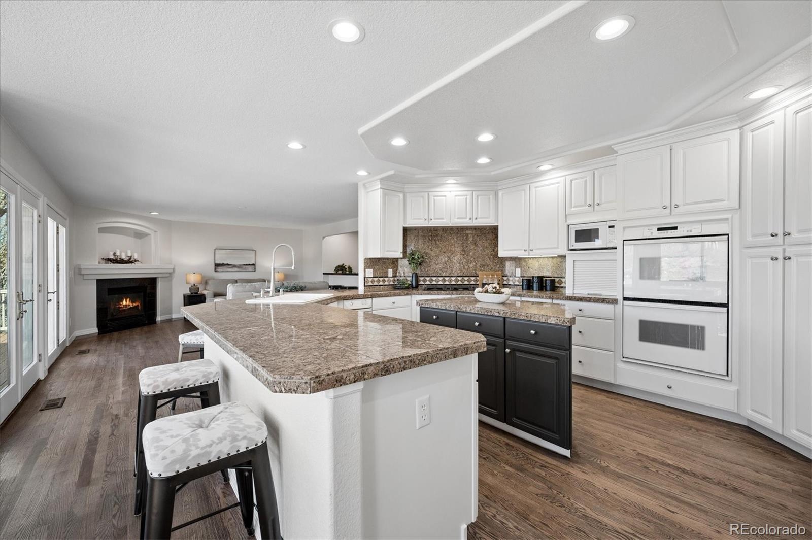 167 South Rogers Way Golden, CO 80401 - Photo 11 of 50 a kitchen with kitchen island granite countertop a sink cabinets and stainless steel appliances