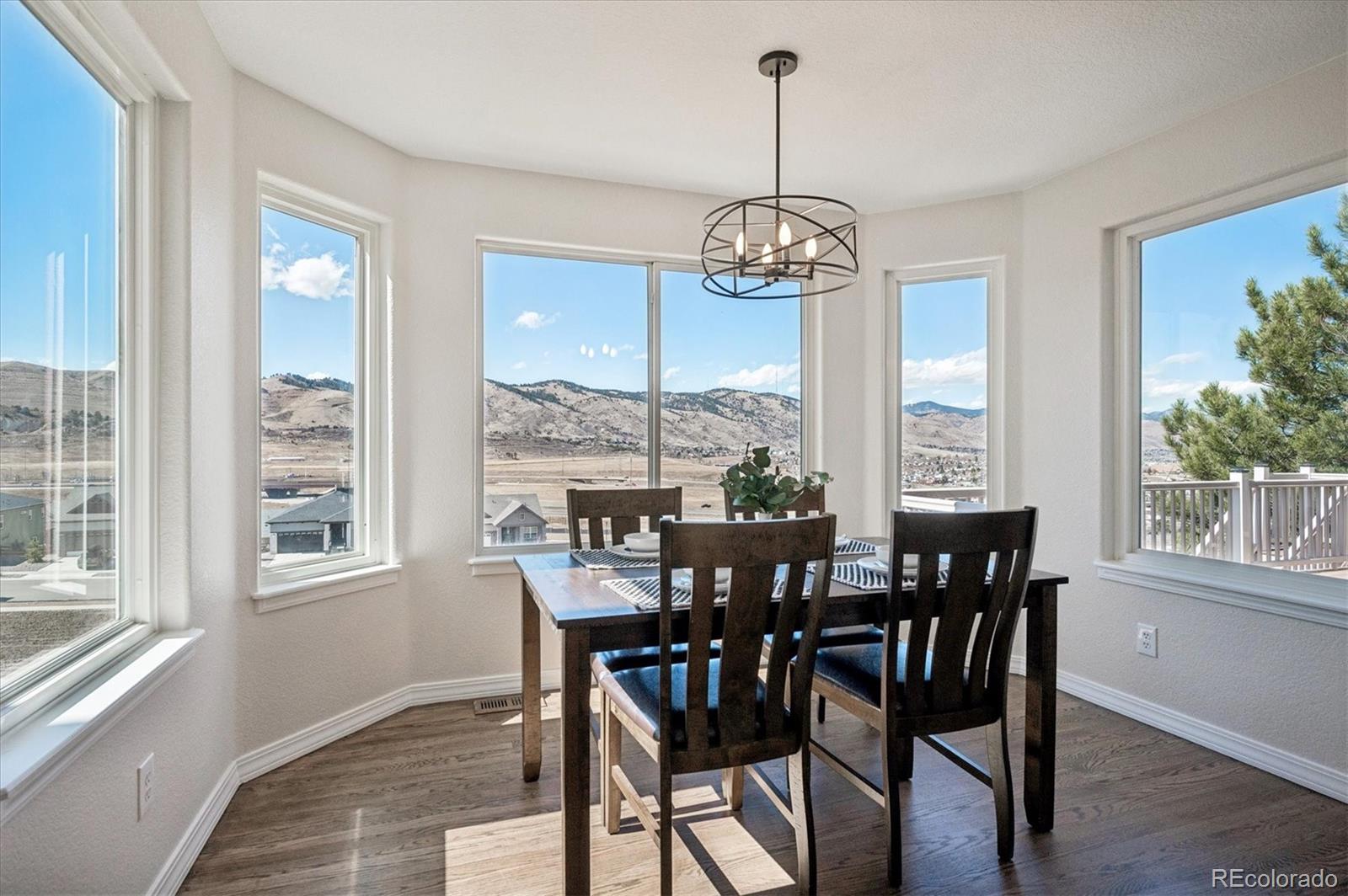167 South Rogers Way Golden, CO 80401 - Photo 13 of 50 a view of a dining room with furniture window and wooden floor