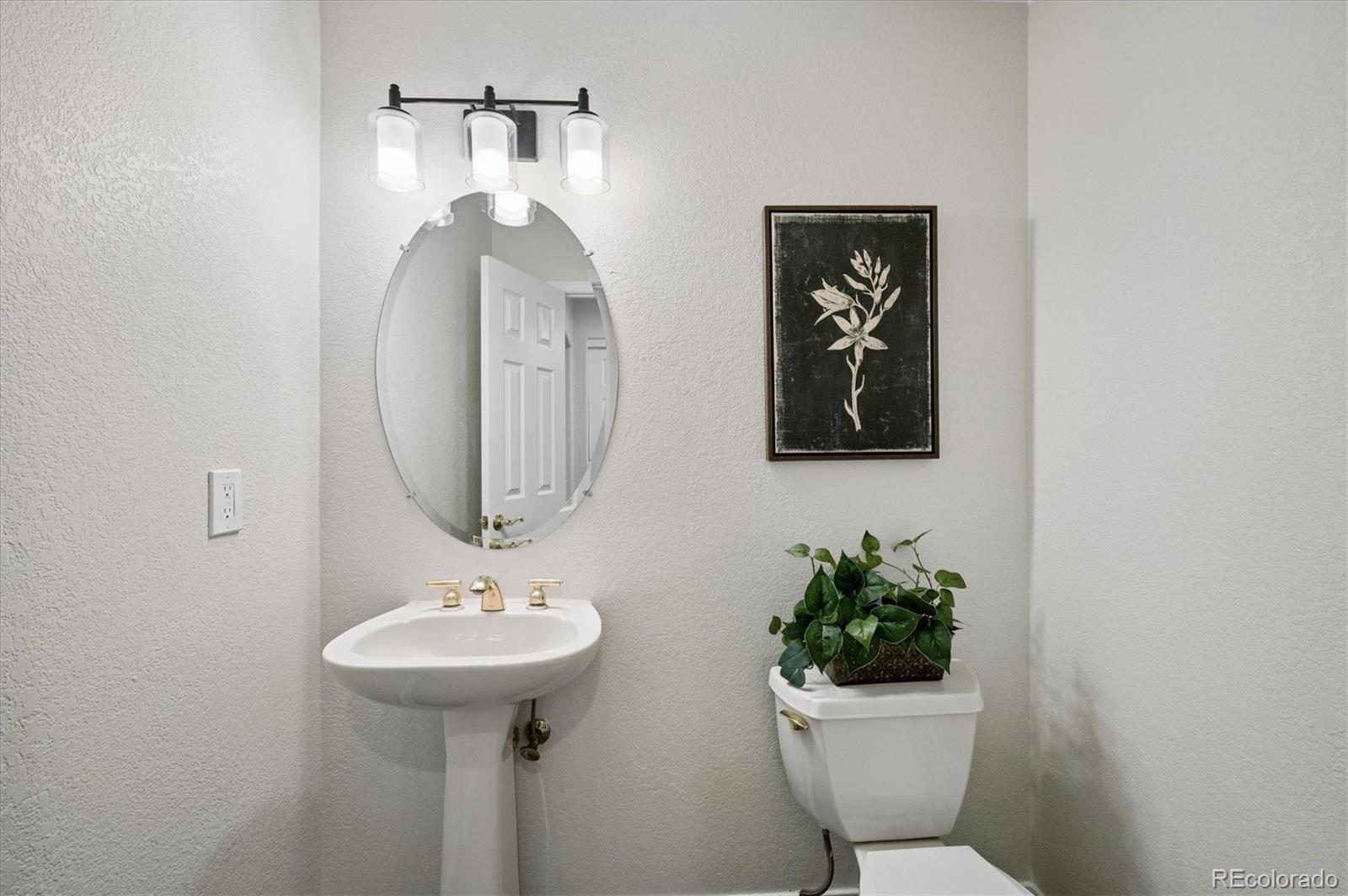 167 South Rogers Way Golden, CO 80401 - Photo 18 of 50 a bathroom with a toilet a sink and mirror