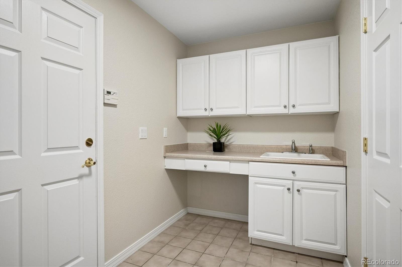 167 South Rogers Way Golden, CO 80401 - Photo 21 of 50 a kitchen with white cabinets
