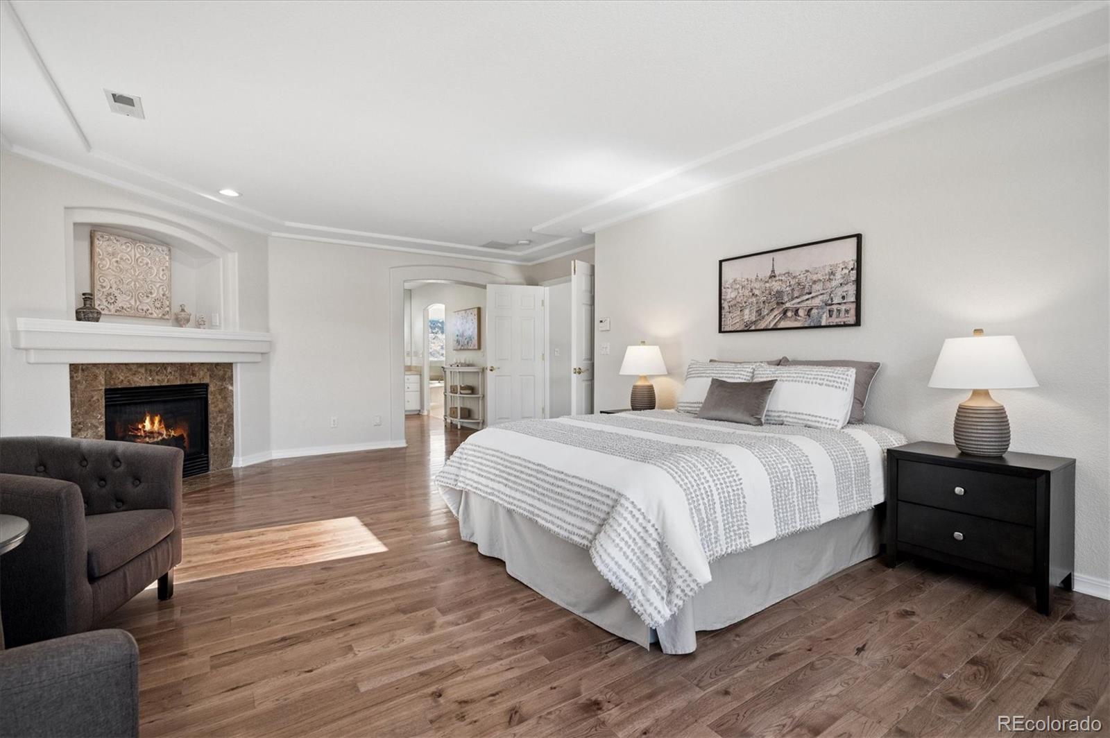 167 South Rogers Way Golden, CO 80401 - Photo 24 of 50 a spacious bedroom with a bed and a fireplace