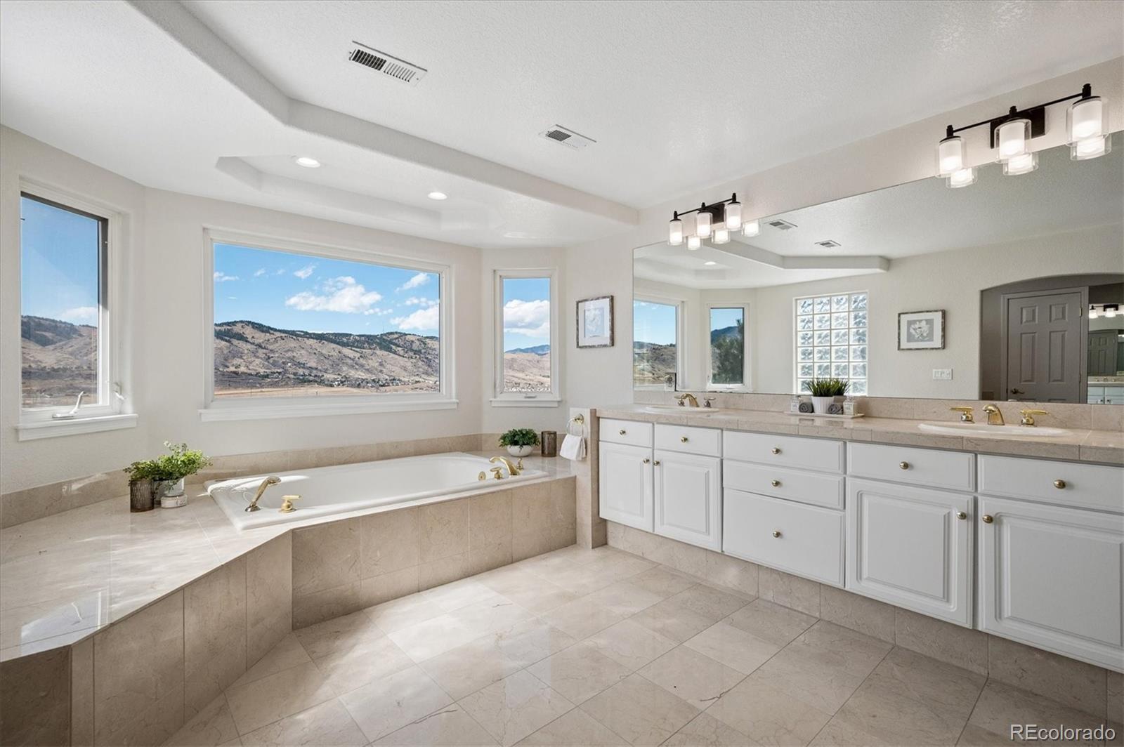 167 South Rogers Way Golden, CO 80401 - Photo 27 of 50 a spacious bathroom with a large tub sink and double vanity