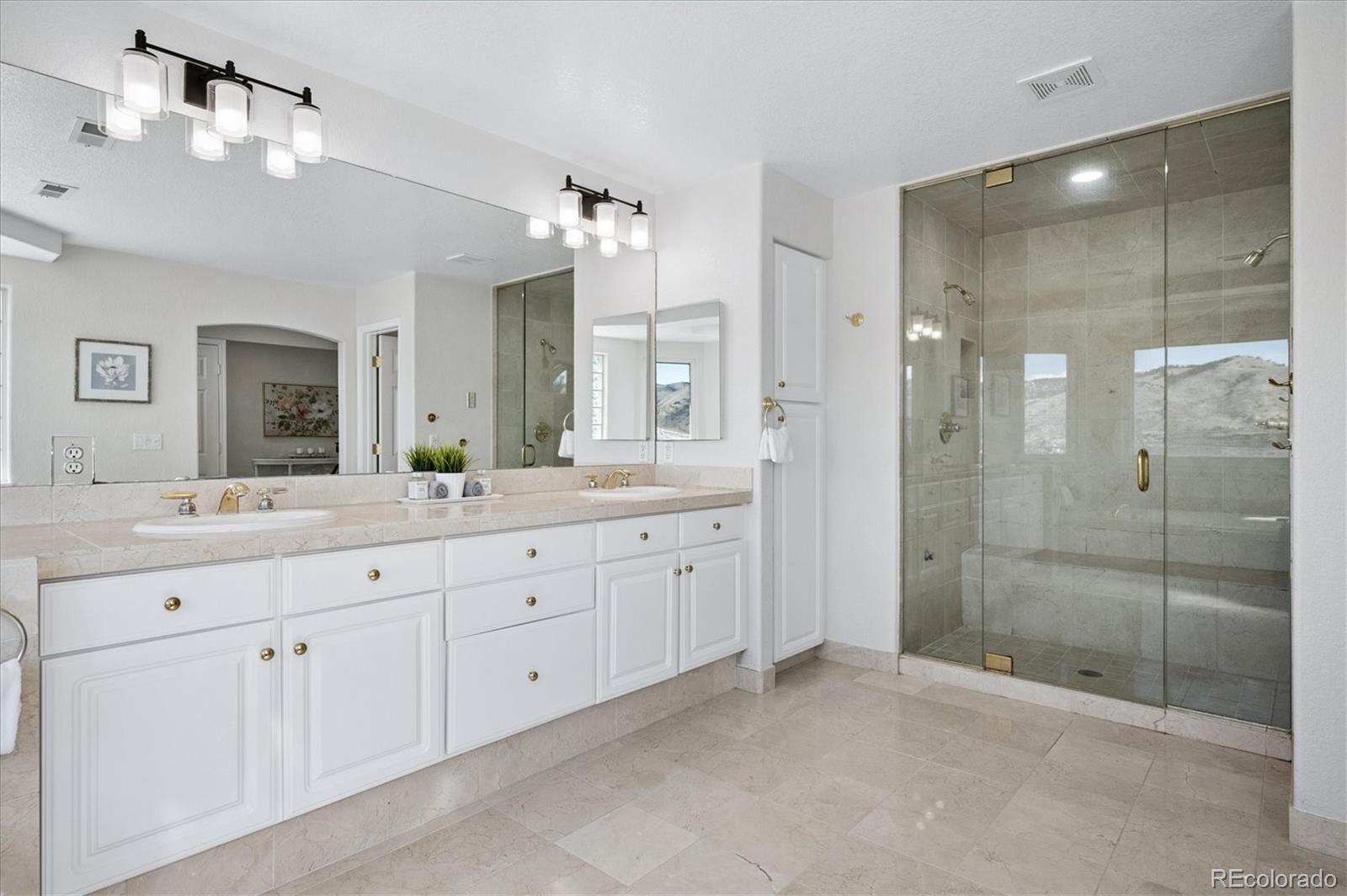 167 South Rogers Way Golden, CO 80401 - Photo 28 of 50 a spacious bathroom with a shower a sink and a mirror