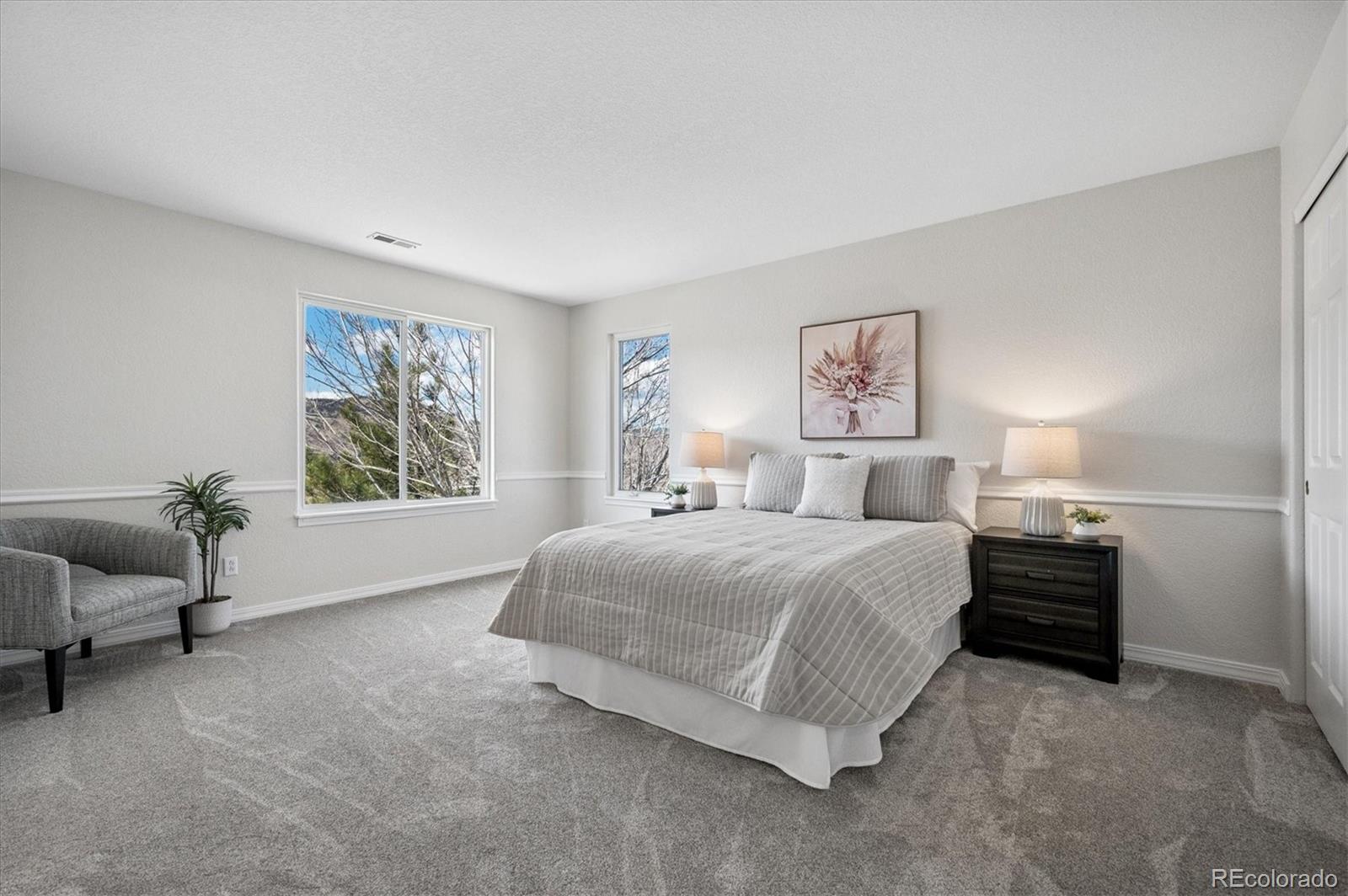 167 South Rogers Way Golden, CO 80401 - Photo 30 of 50 a spacious bedroom with a bed and a couch