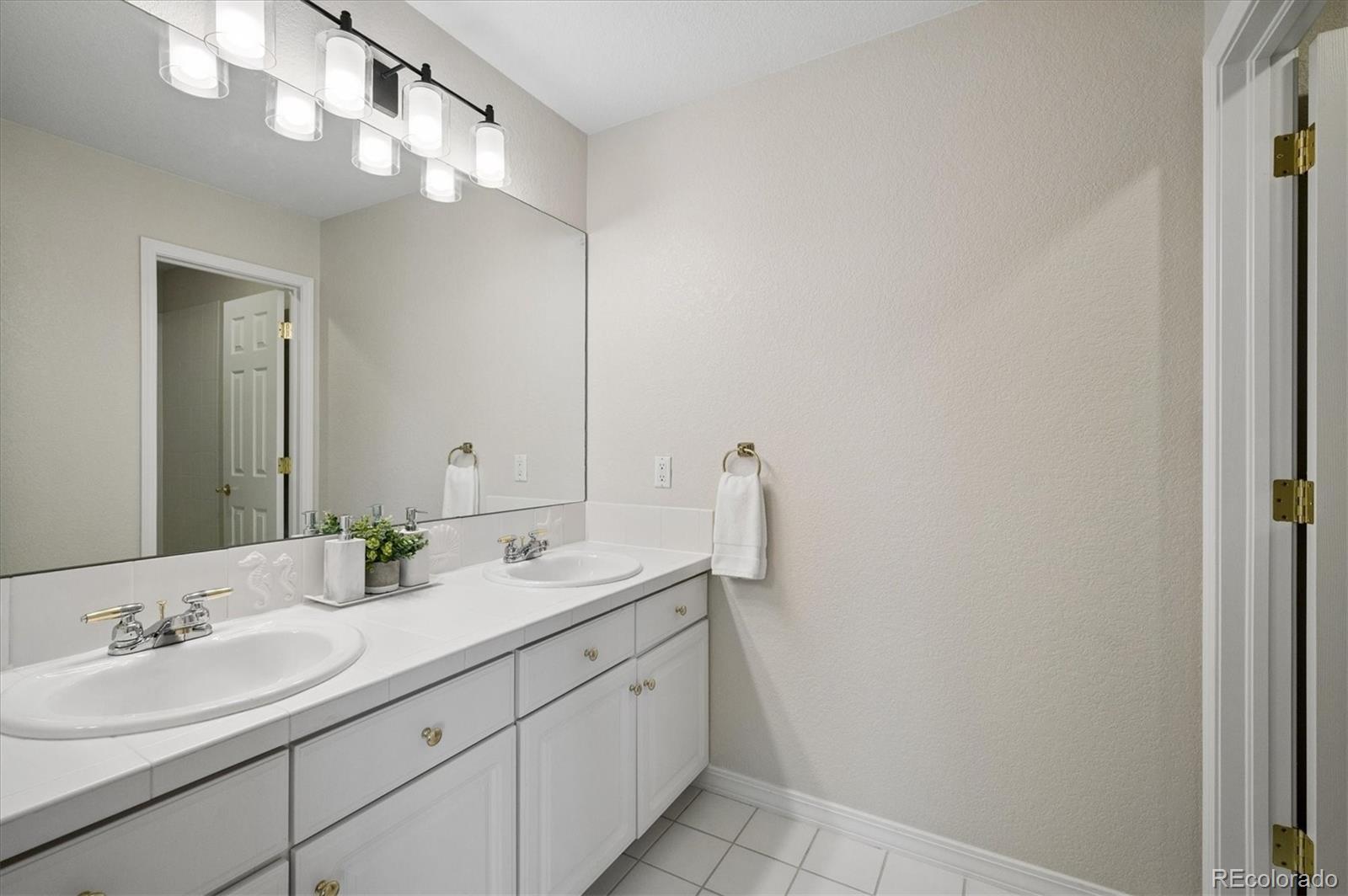 167 South Rogers Way Golden, CO 80401 - Photo 31 of 50 a bathroom with a double vanity sink and a mirror