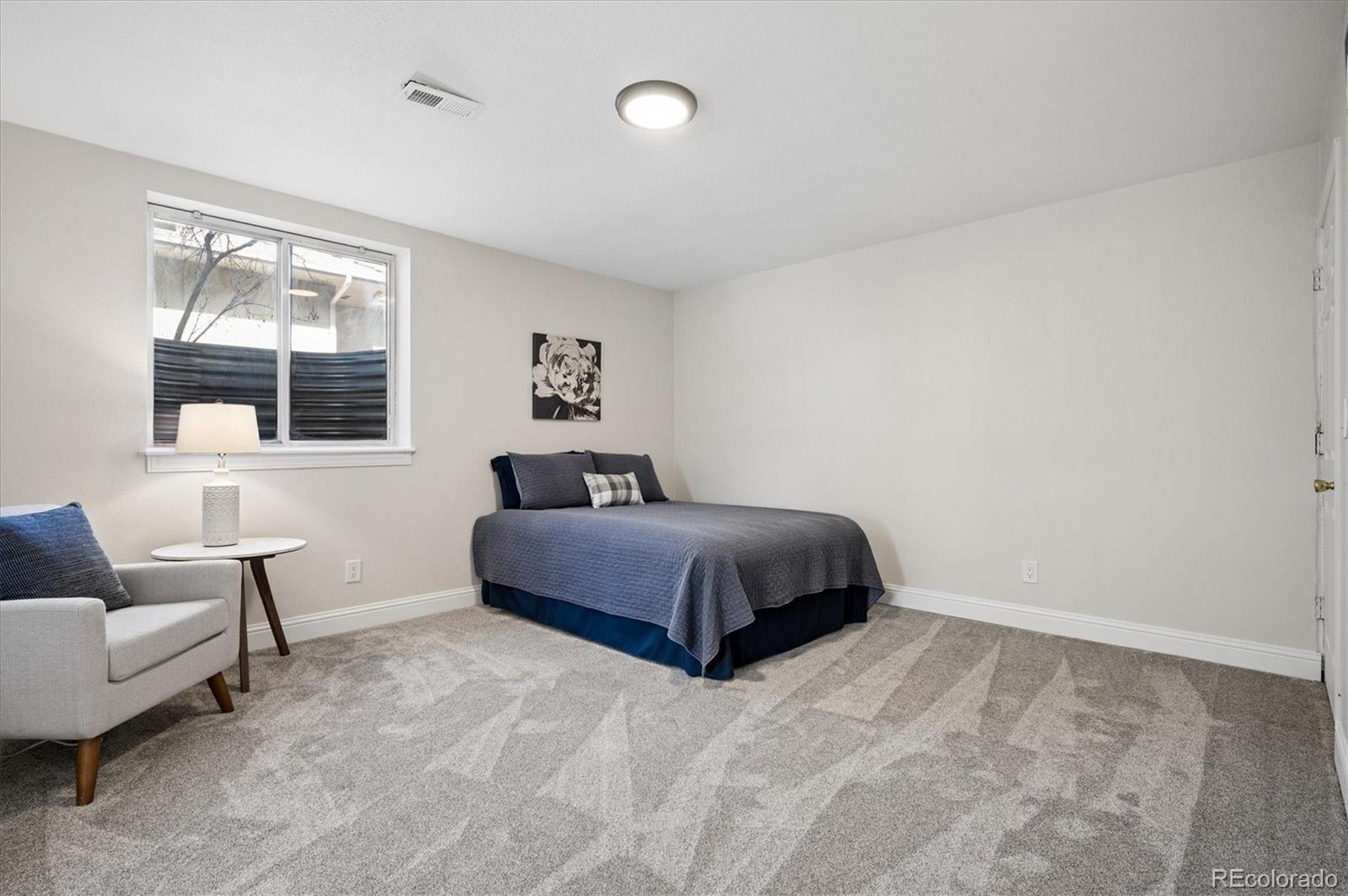 167 South Rogers Way Golden, CO 80401 - Photo 41 of 50 a bedroom with a large bed and a couch