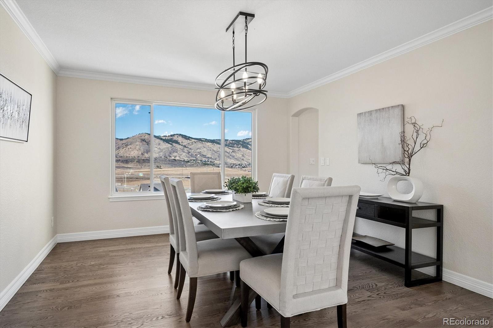 167 South Rogers Way Golden, CO 80401 - Photo 9 of 50 a dining room with furniture a chandelier and wooden floor