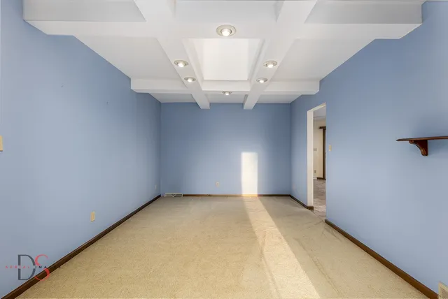 an empty room with a ceiling fan and window