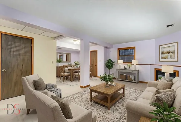 a living room with furniture and a fireplace