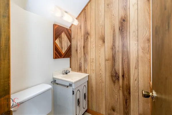 a bathroom with a sink toilet and vanity