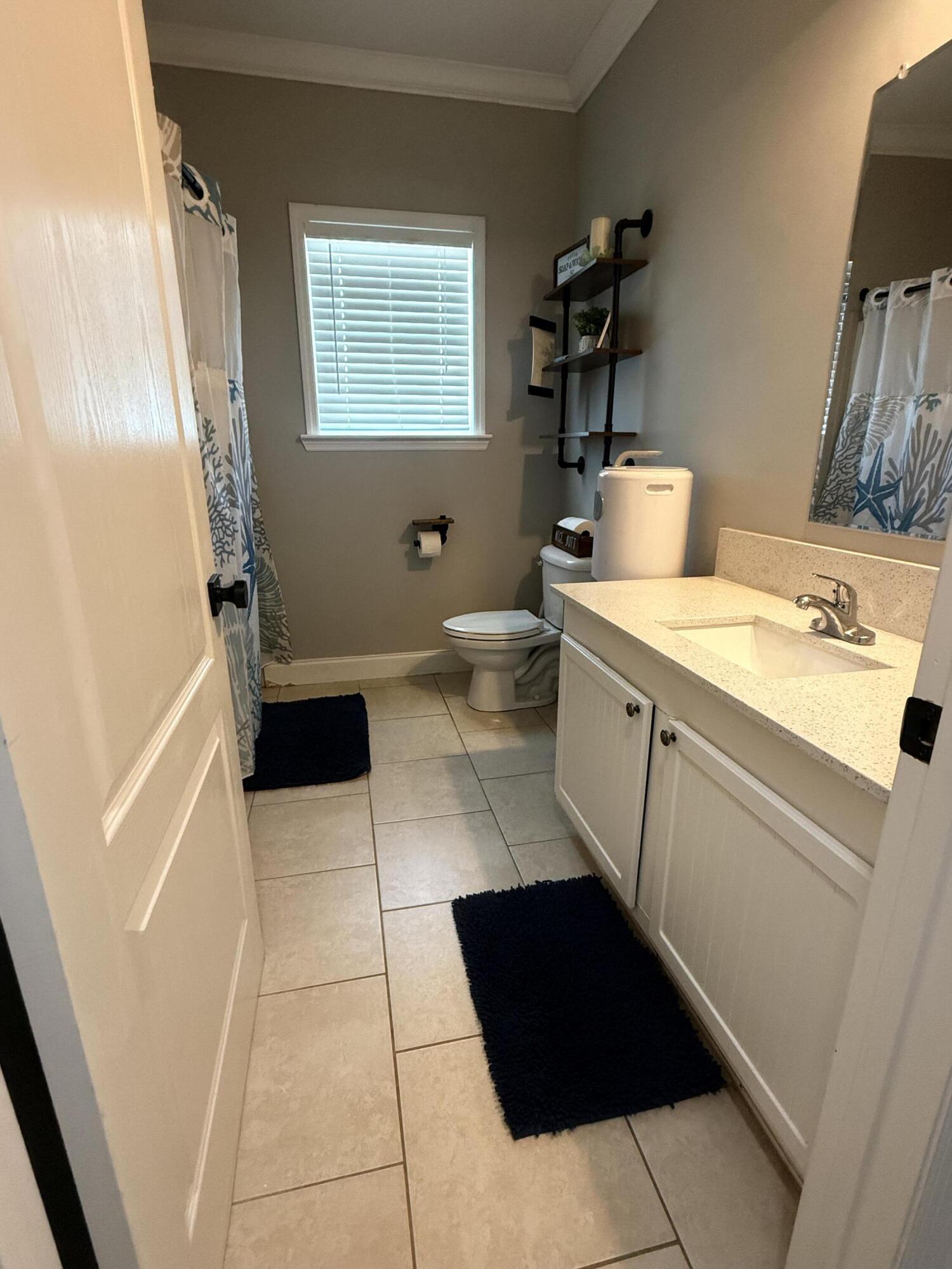 314 Ave D Key West, FL 33040 - Photo 11 of 23 a room with a sink a toilet and a mirror