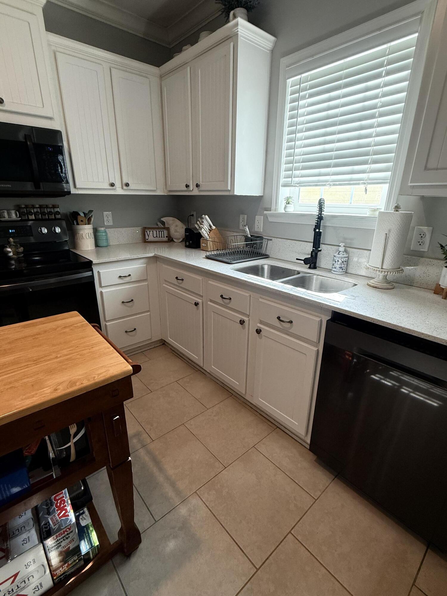 314 Ave D Key West, FL 33040 - Photo 20 of 23 a kitchen with stainless steel appliances granite countertop a sink counter space cabinets and a window