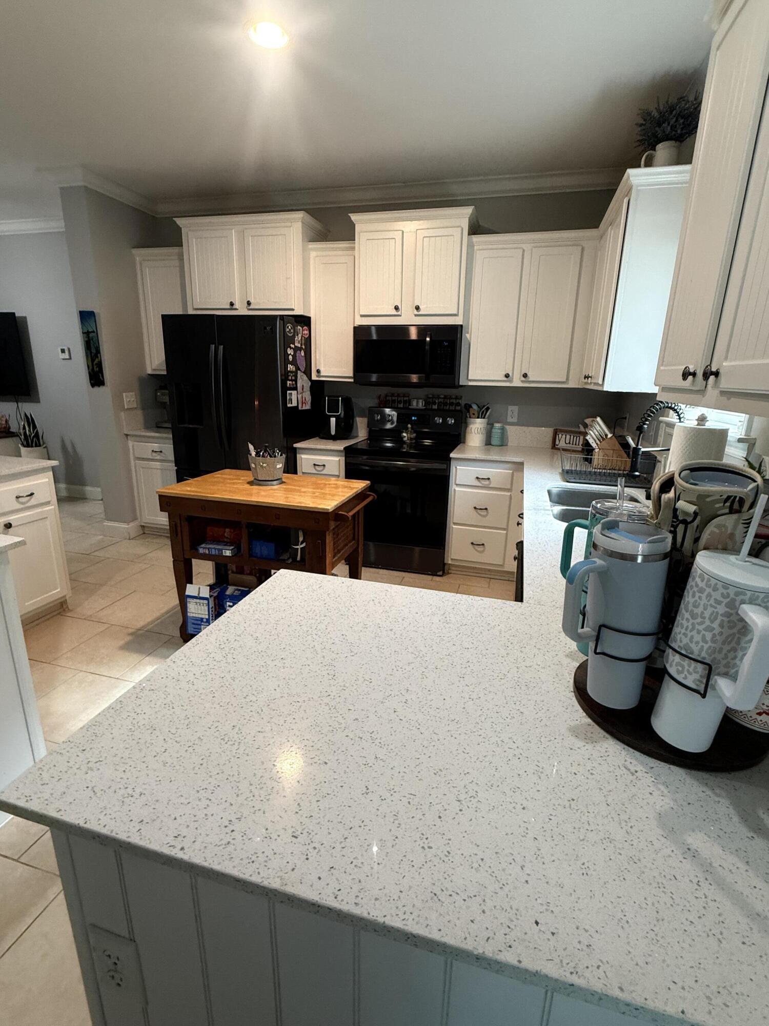 314 Ave D Key West, FL 33040 - Photo 21 of 23 a kitchen with a sink a stove and cabinets
