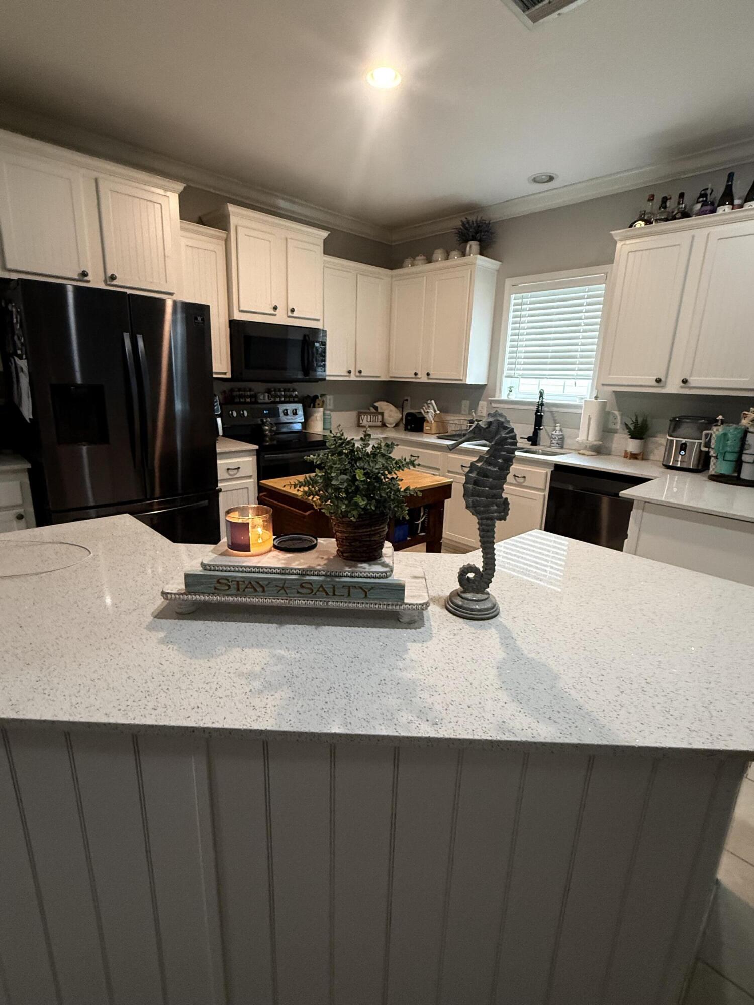 314 Ave D Key West, FL 33040 - Photo 22 of 23 a kitchen with a sink and a stove top oven with wooden floor