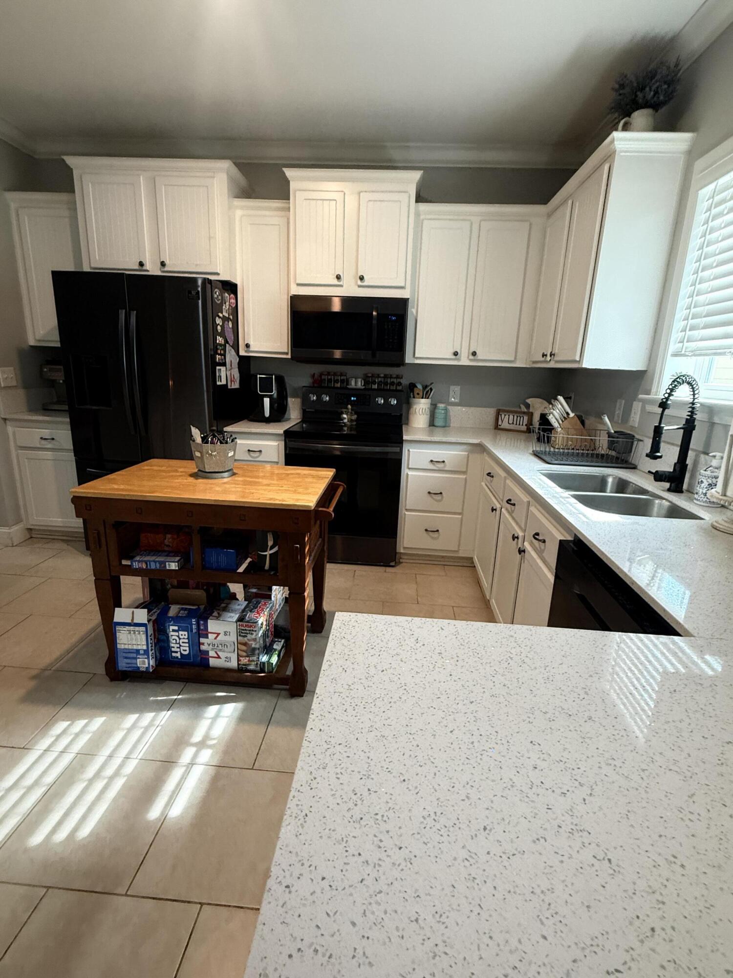 314 Ave D Key West, FL 33040 - Photo 23 of 23 a kitchen with stainless steel appliances kitchen island granite countertop a refrigerator a sink a stove and blue cabinets