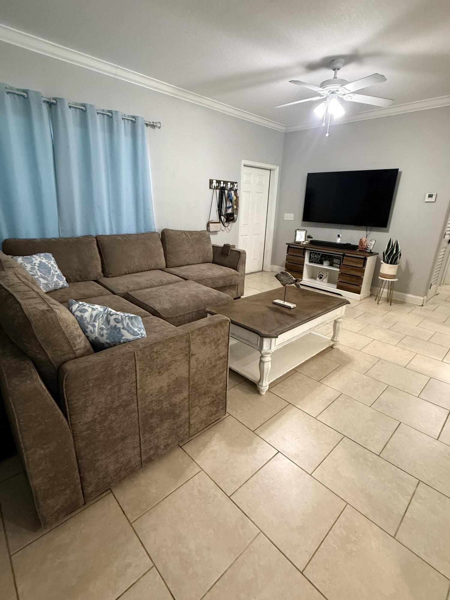 314 Ave D Key West, FL 33040 - Photo 8 of 23 a living room with furniture and a flat screen tv