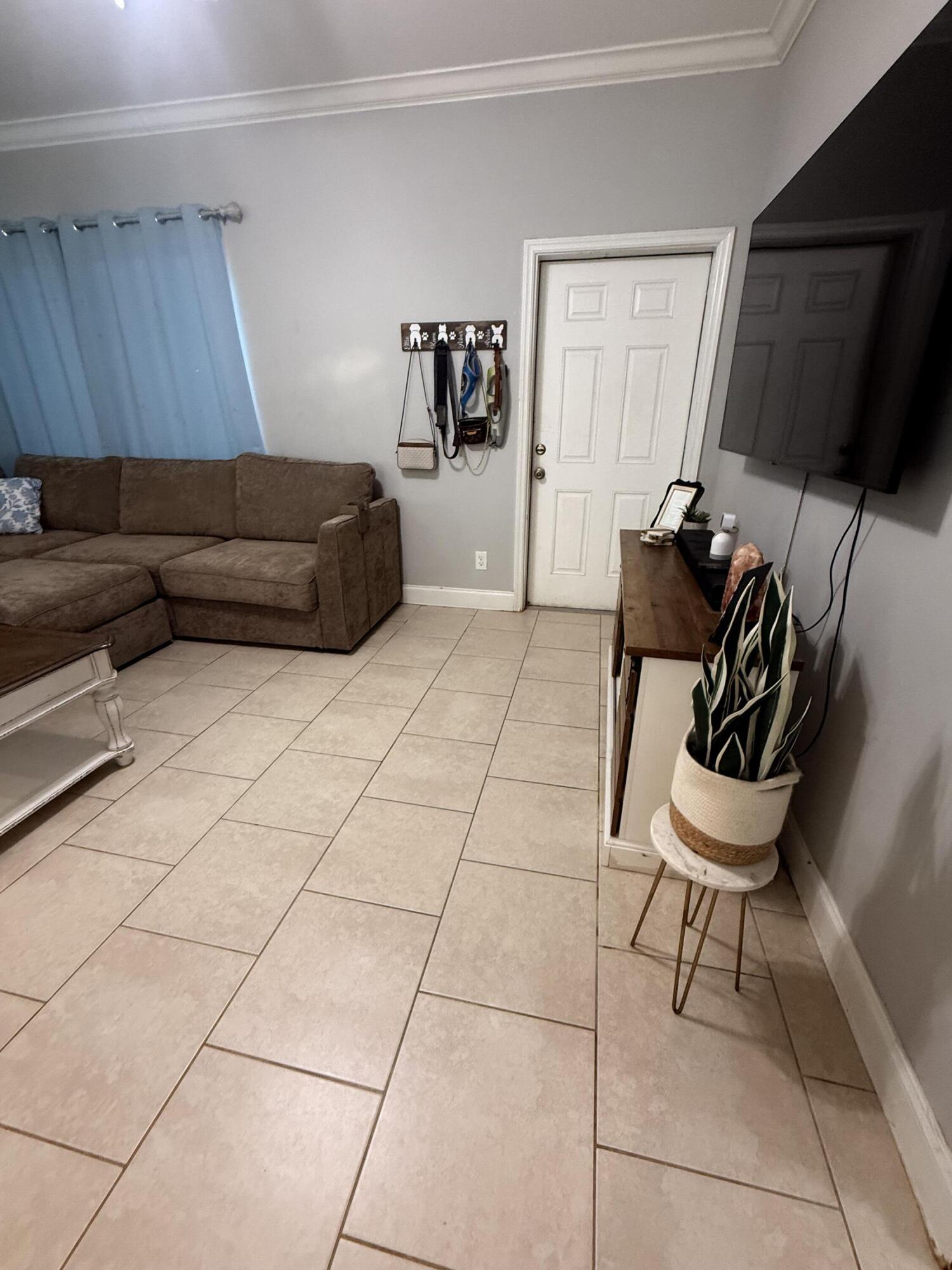314 Ave D Key West, FL 33040 - Photo 10 of 23 a living room with a couch and a flat screen tv