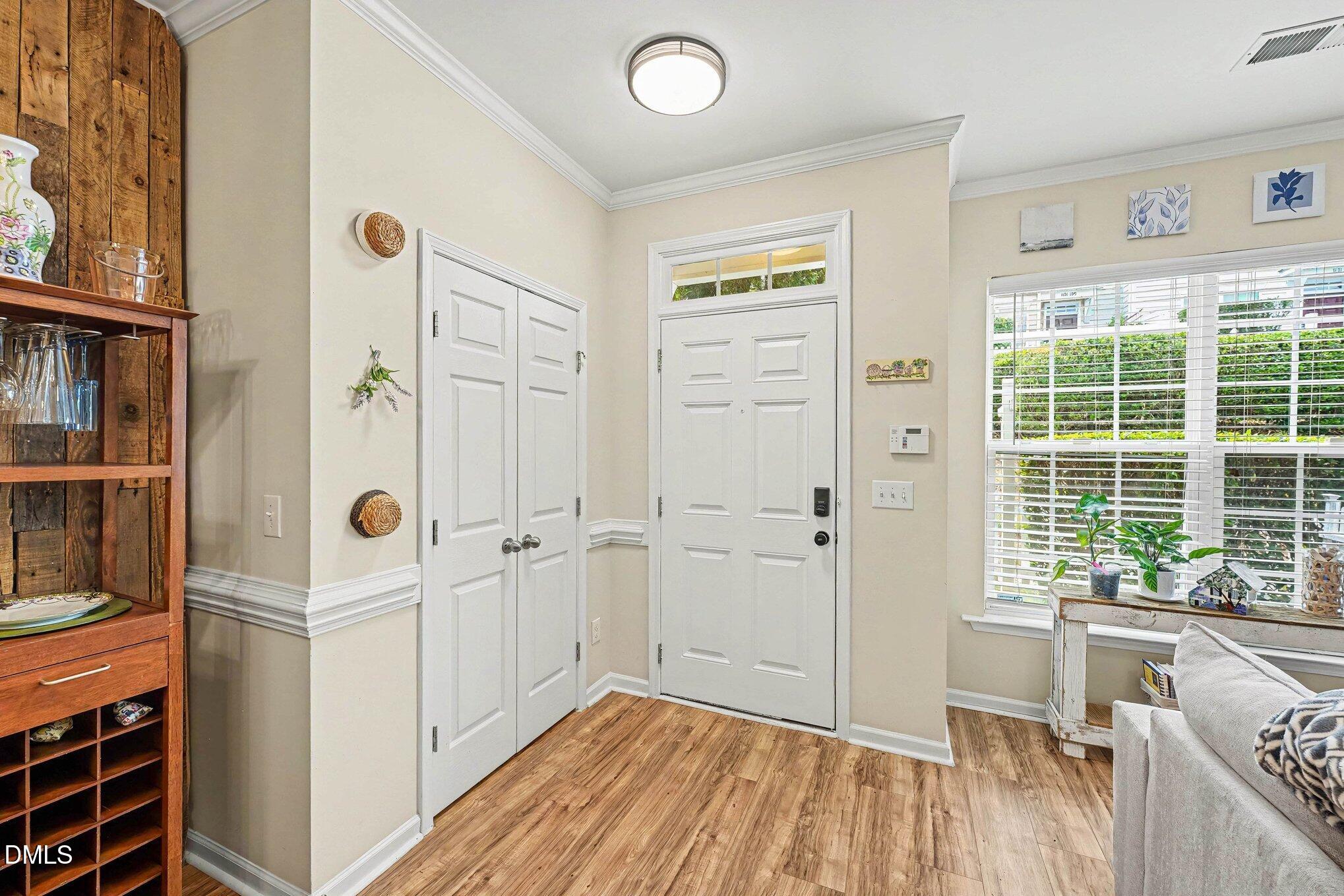 1130 Renewal Place, Unit 106 Raleigh, NC 27603 - Photo 3 of 34 a view of a hallway with wooden floor and windows