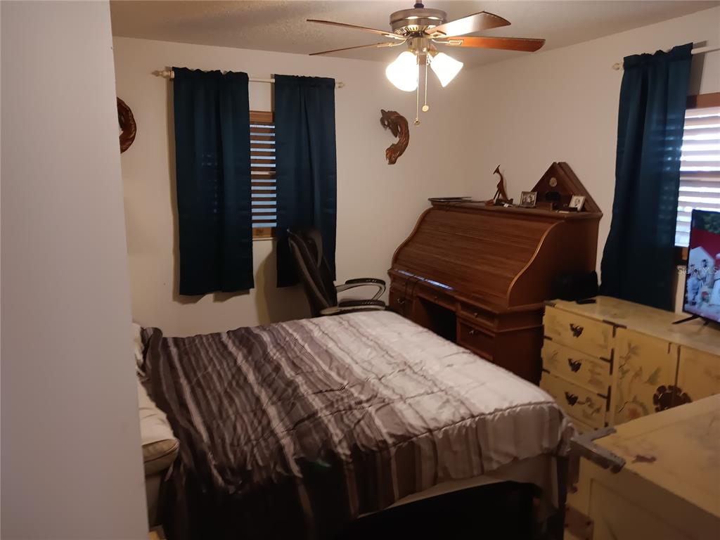 374 3rd Street Northwest Largo, FL 33770 - Photo 12 of 31 a bedroom with a bed and a chandelier