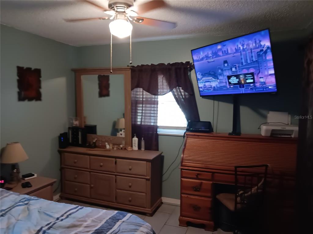 374 3rd Street Northwest Largo, FL 33770 - Photo 13 of 31 a room with a bed and a chandelier