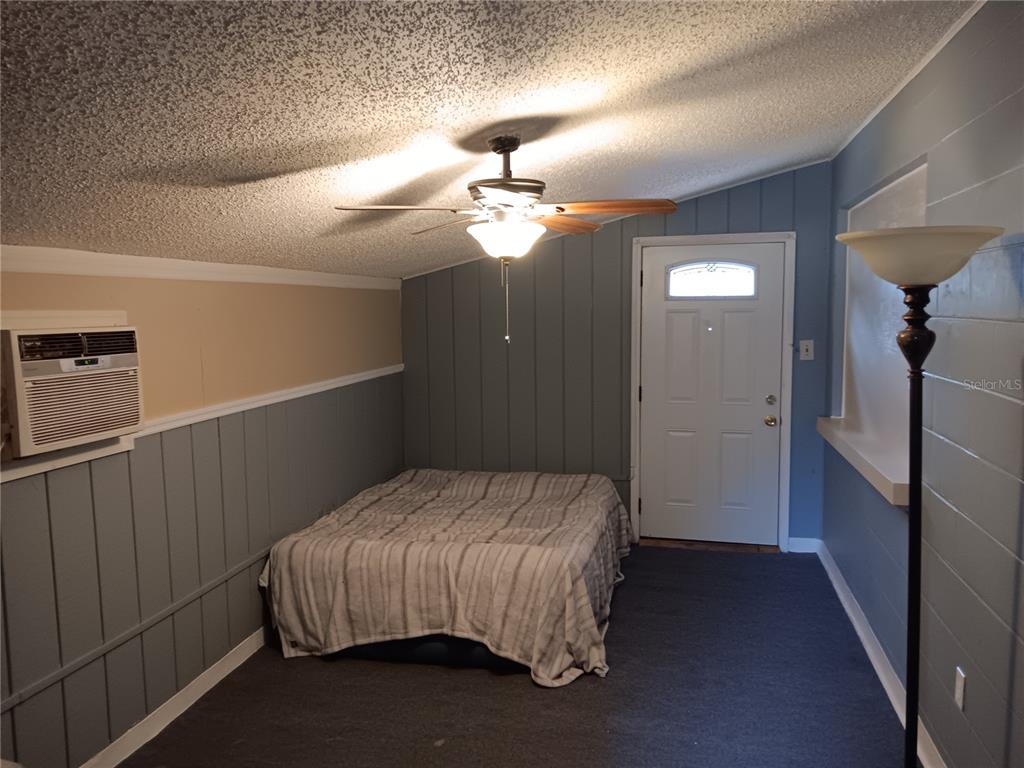 374 3rd Street Northwest Largo, FL 33770 - Photo 16 of 31 a bedroom with a bed and a chandelier