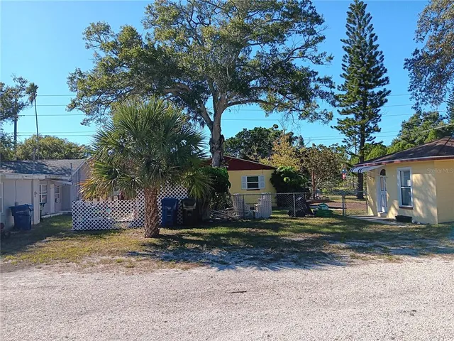 a view of a house with backyard and a tree