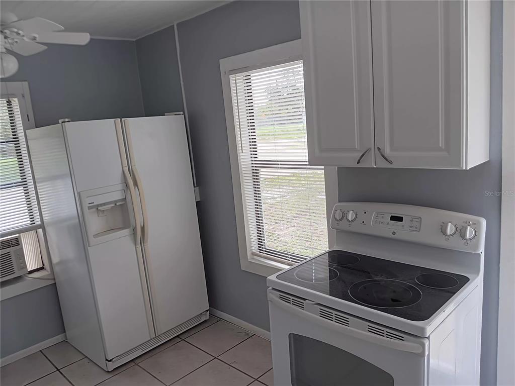 374 3rd Street Northwest Largo, FL 33770 - Photo 28 of 31 a kitchen with a refrigerator sink and stove