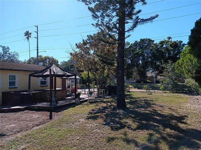 a view of a house with backyard porch and sitting area