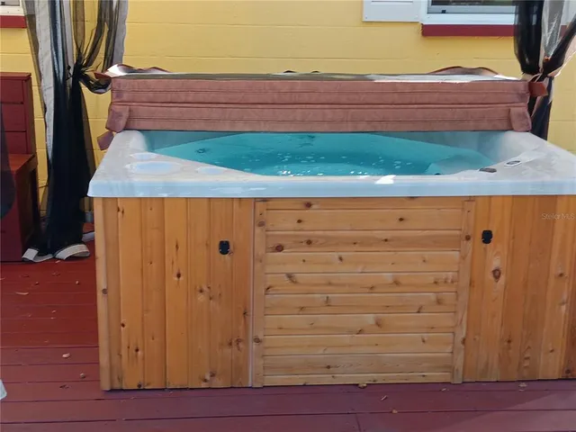a view of a patio with table and chairs potted plants and a barbeque