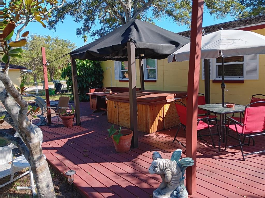 374 3rd Street Northwest Largo, FL 33770 - Photo 7 of 31 a view of a patio with table and chairs potted plants and a barbeque