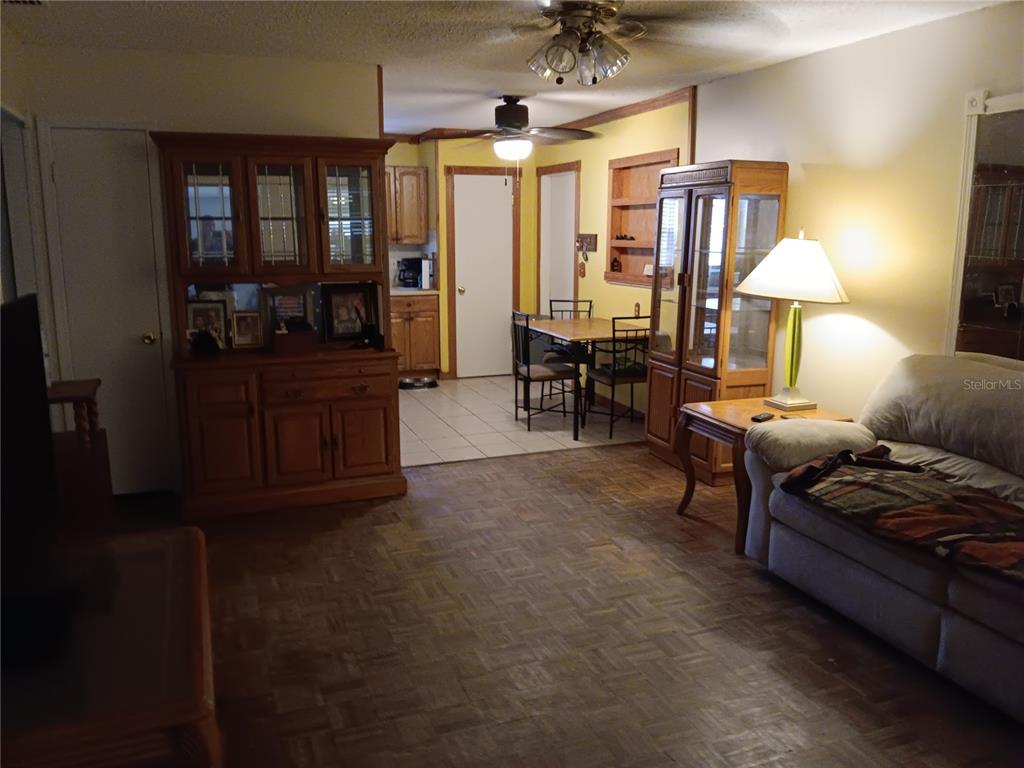 374 3rd Street Northwest Largo, FL 33770 - Photo 9 of 31 a living room with furniture and a lamp