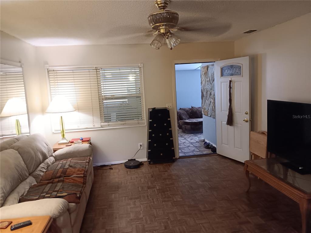 374 3rd Street Northwest Largo, FL 33770 - Photo 10 of 31 a living room with furniture and a flat screen tv