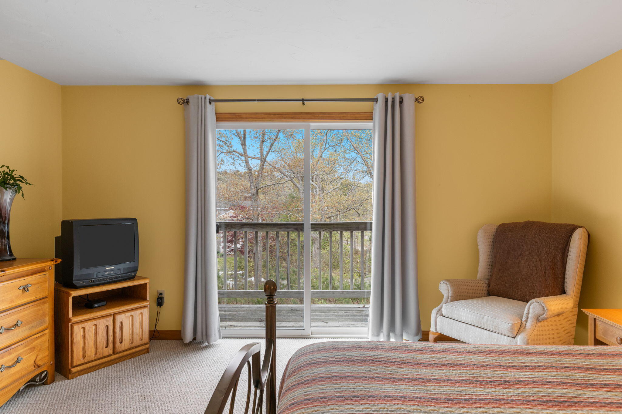 285 Blue Heron Road Wellfleet, MA 02667 - Photo 17 of 31 a bedroom with furniture and a flat screen tv