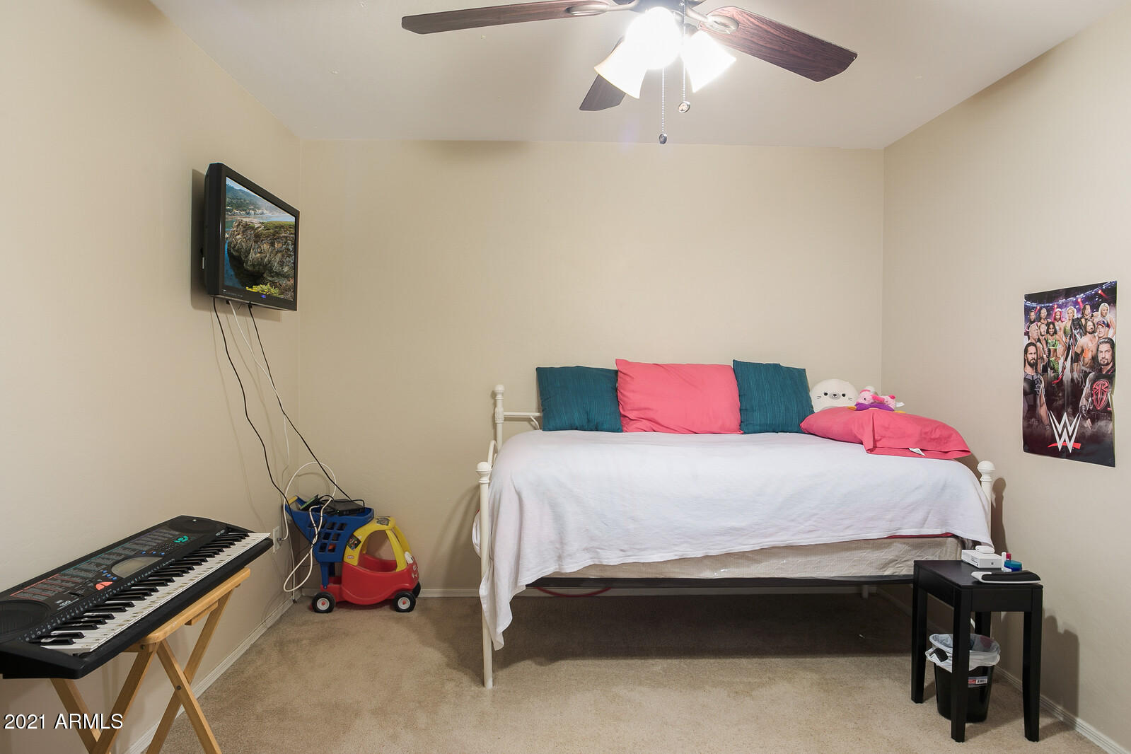 1114 East Fraktur Road Phoenix, AZ 85040 - Photo 16 of 23 a bedroom with a bed and a flat tv screen on a dresser