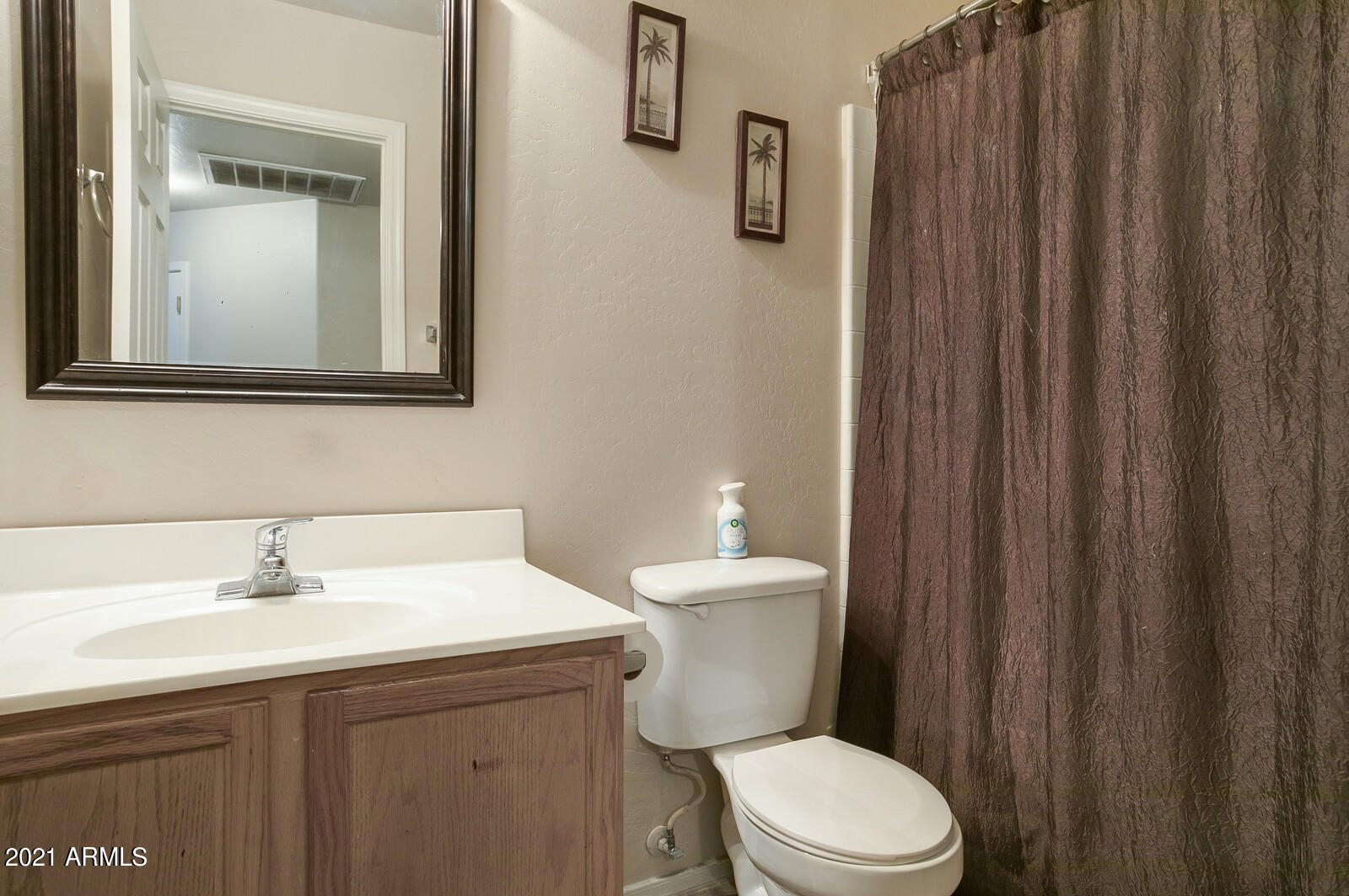 1114 East Fraktur Road Phoenix, AZ 85040 - Photo 19 of 23 a bathroom with a toilet a sink and mirror