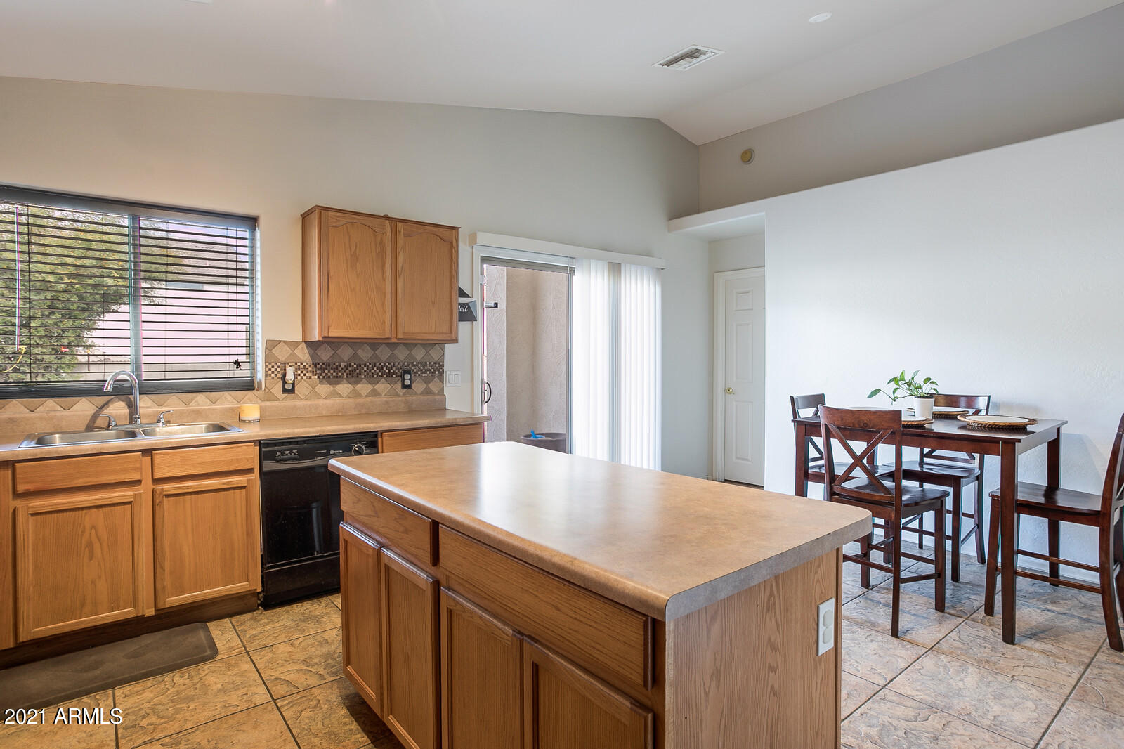 1114 East Fraktur Road Phoenix, AZ 85040 - Photo 10 of 23 a kitchen with a stove a sink a dining table and chairs