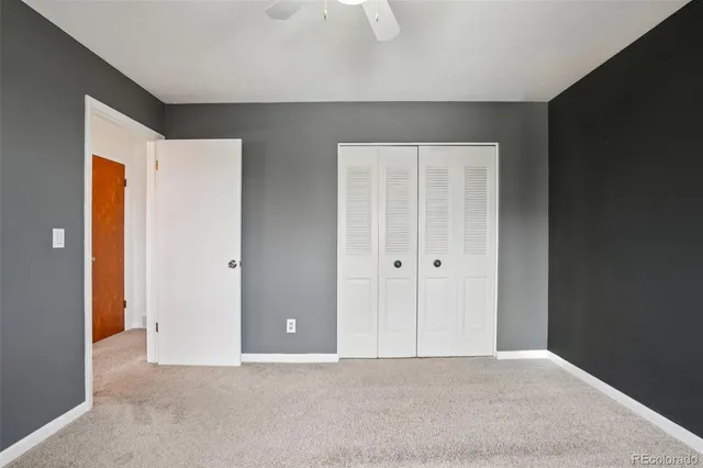 a spacious bedroom with a large bed and a chandelier