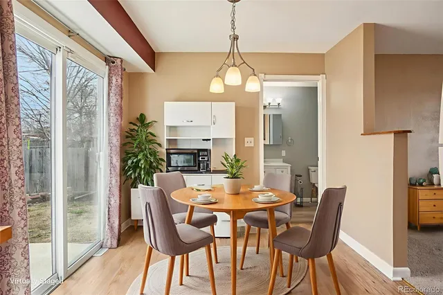 a kitchen with granite countertop a stove top oven a sink and white cabinets