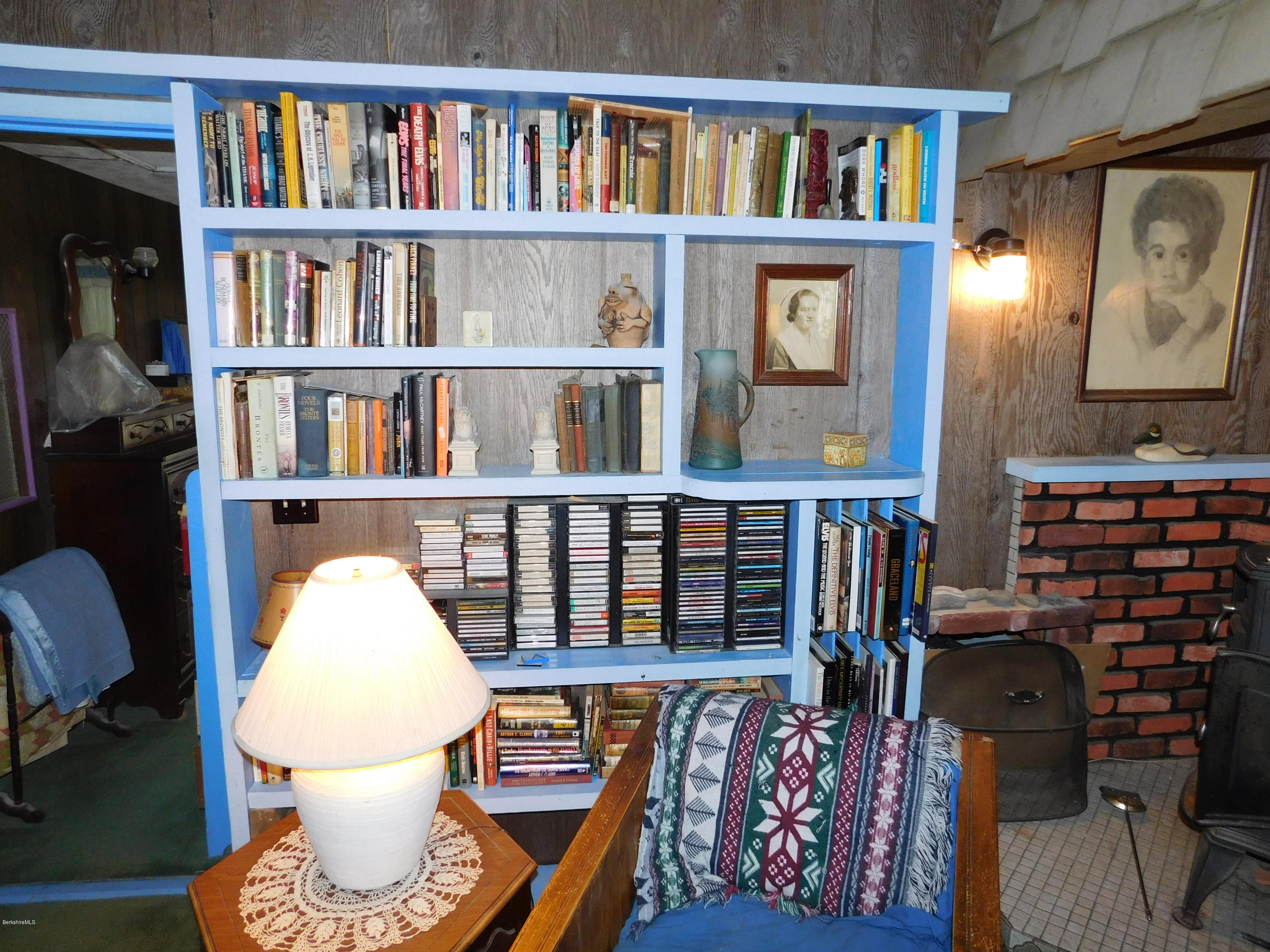 94 River Road Savoy, MA 01256 - Photo 11 of 36 a living room with furniture a book shelf and a book shelf