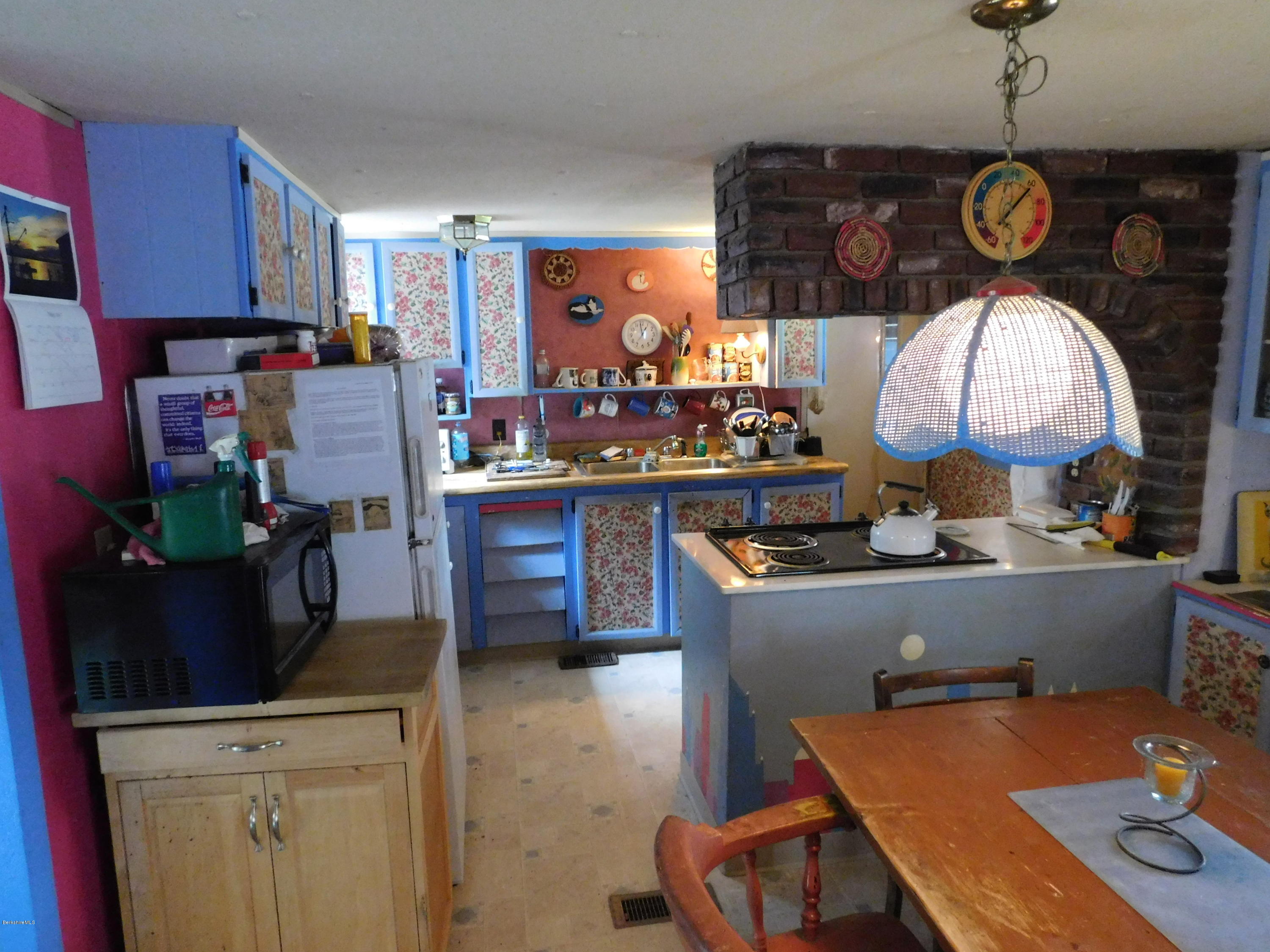 94 River Road Savoy, MA 01256 - Photo 16 of 36 a kitchen with a refrigerator and a stove top oven