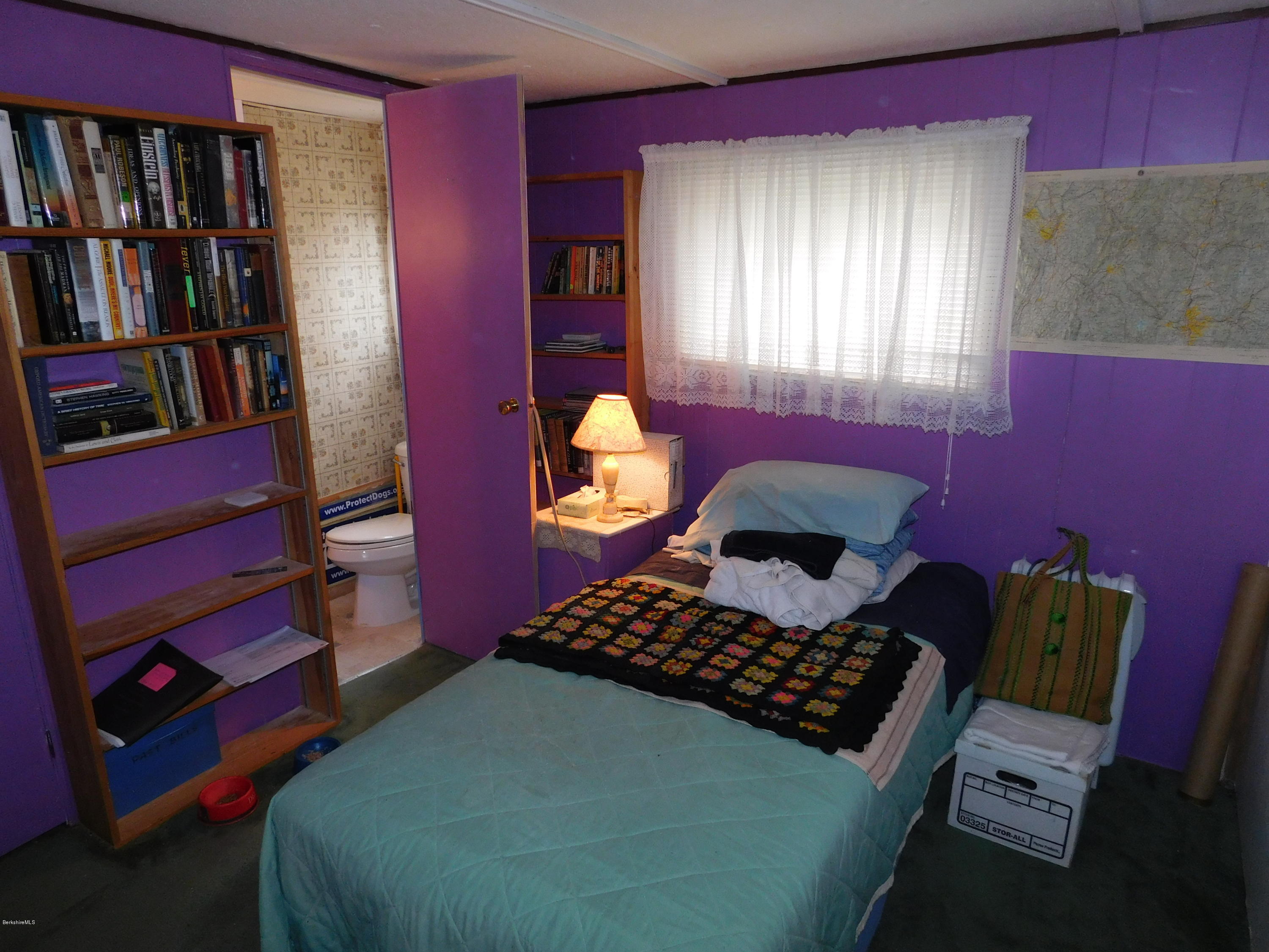 94 River Road Savoy, MA 01256 - Photo 24 of 36 a bedroom with a bed and a book shelf