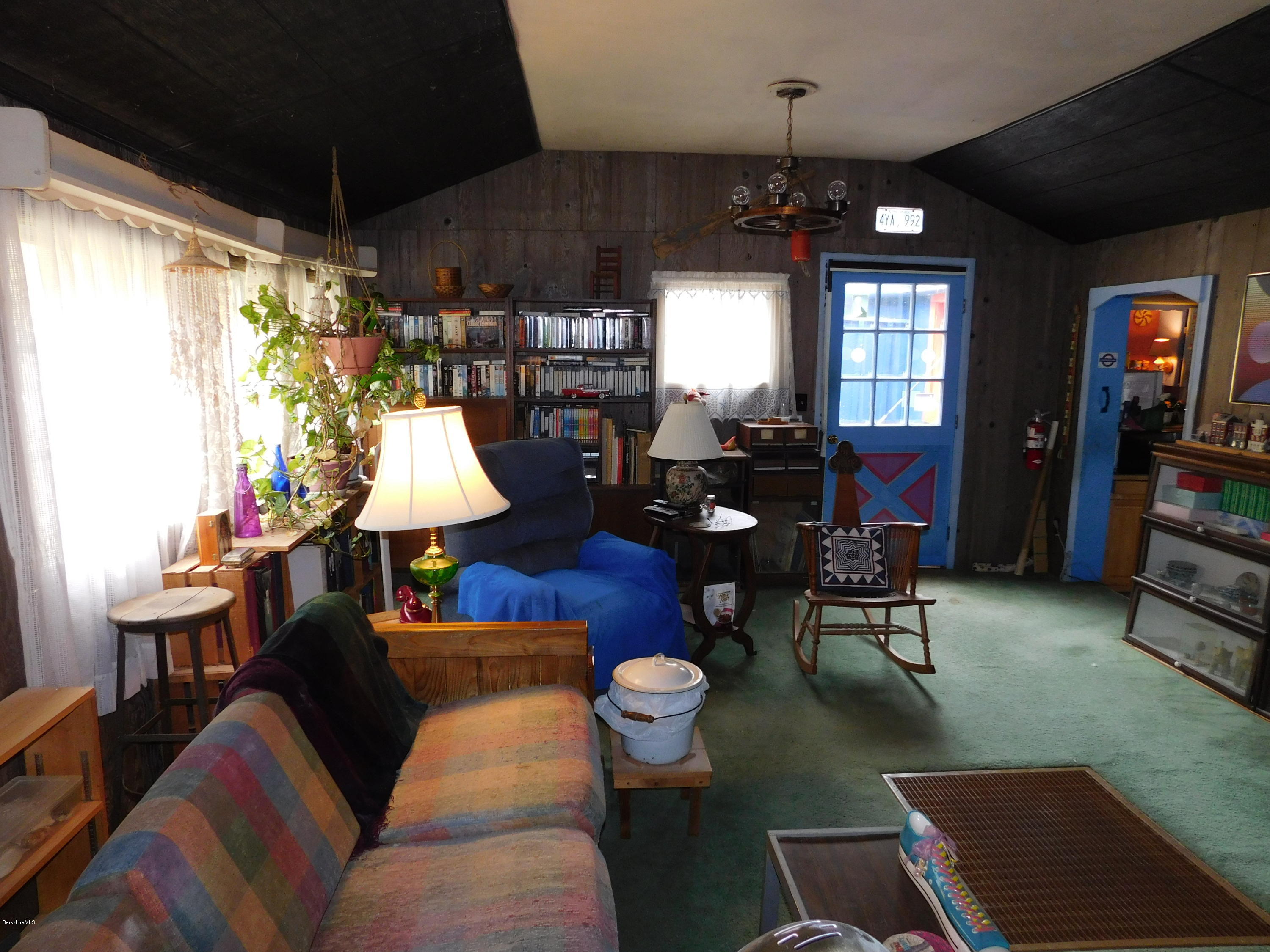94 River Road Savoy, MA 01256 - Photo 35 of 36 a living room with furniture a chandelier and a window
