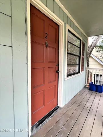 a view of front door of a house with wooden floor