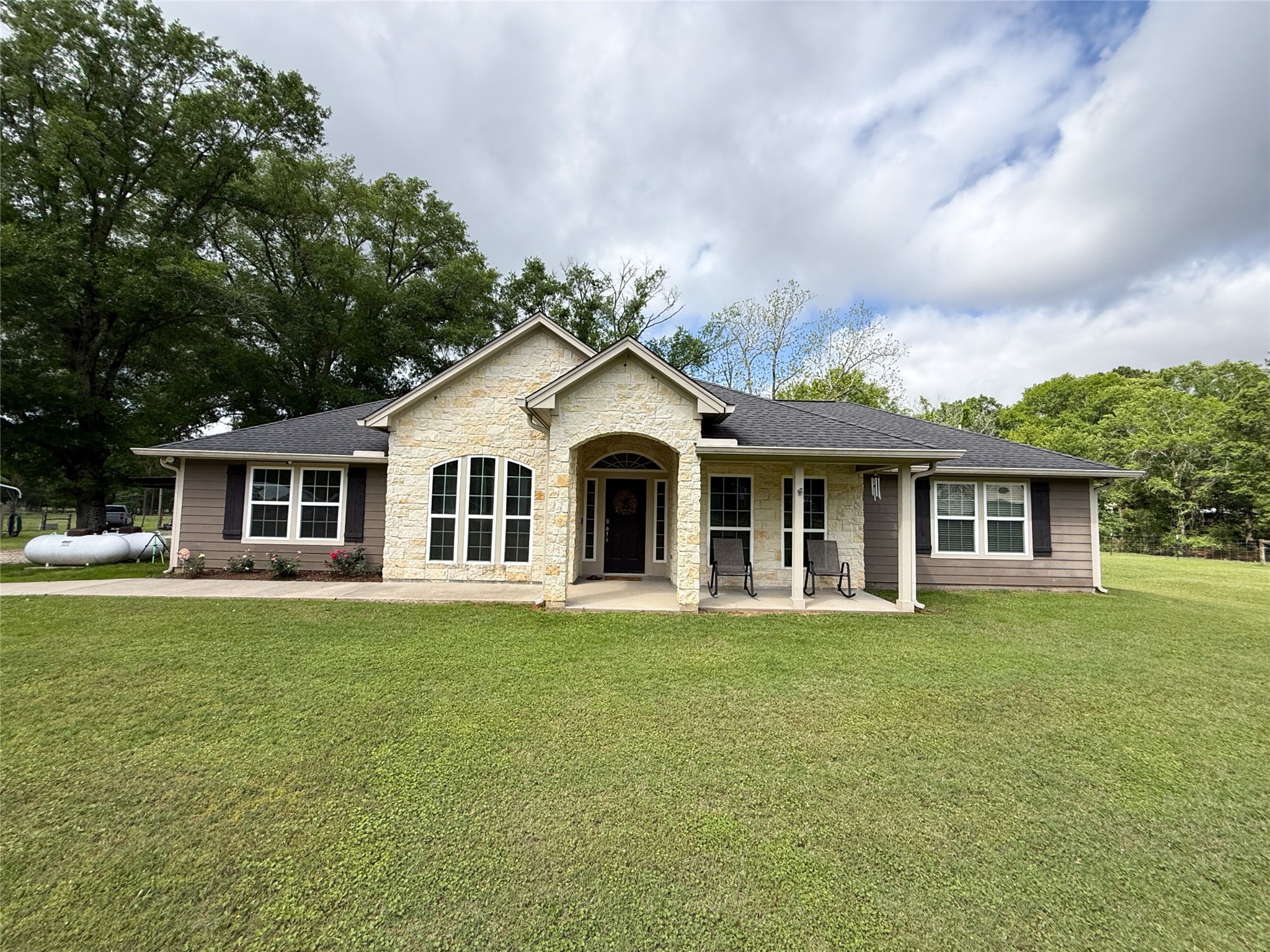 12220 Fm 356 Trinity, TX 75862 - Photo 4 of 50 a front view of a house with a garden