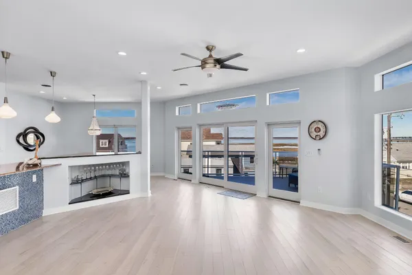 a kitchen with stainless steel appliances kitchen island granite countertop a refrigerator a oven a sink with island and chairs