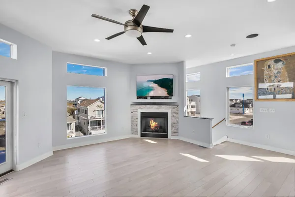 a kitchen with stainless steel appliances granite countertop a sink a stove and a wooden floors